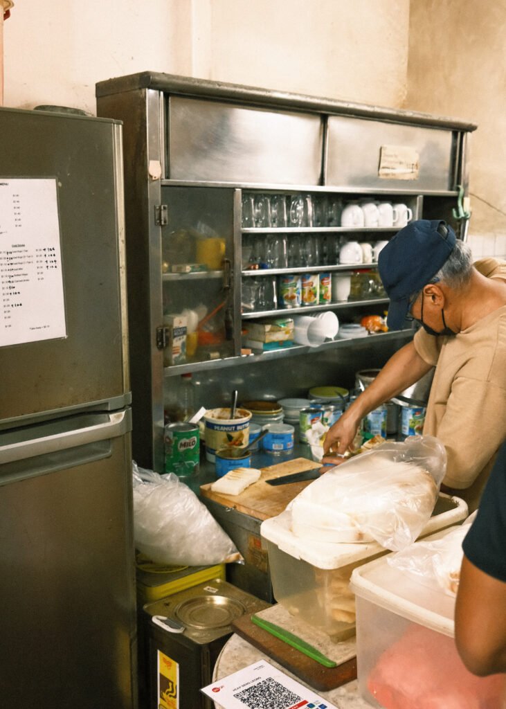 man making toast in singapore coffee stand